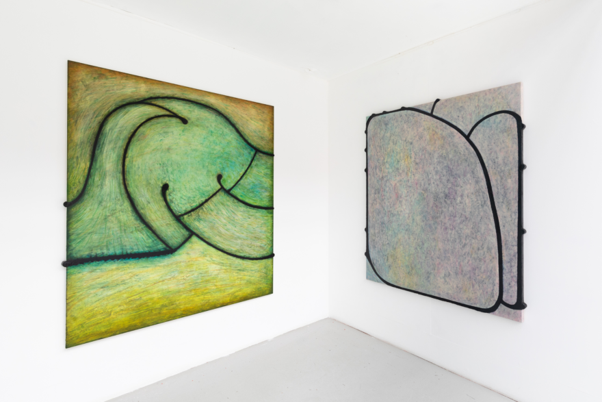 Two abstract paintings on canvas in pastel colors: on the right side a blue and yellow hued organic object and on the right side a grey-yellow organic shaped motive.