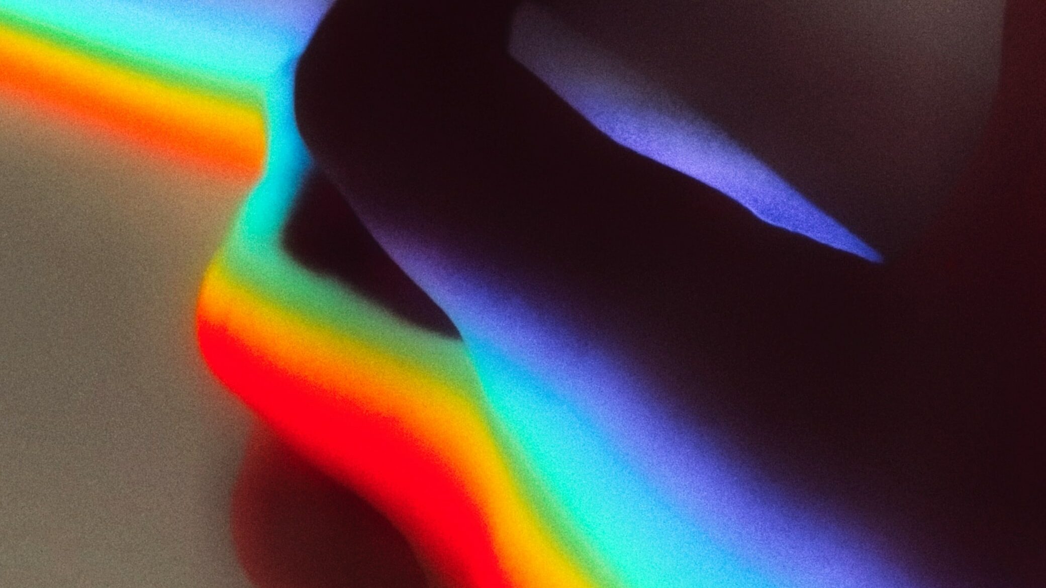 A hand with rainbow colors floating into space.