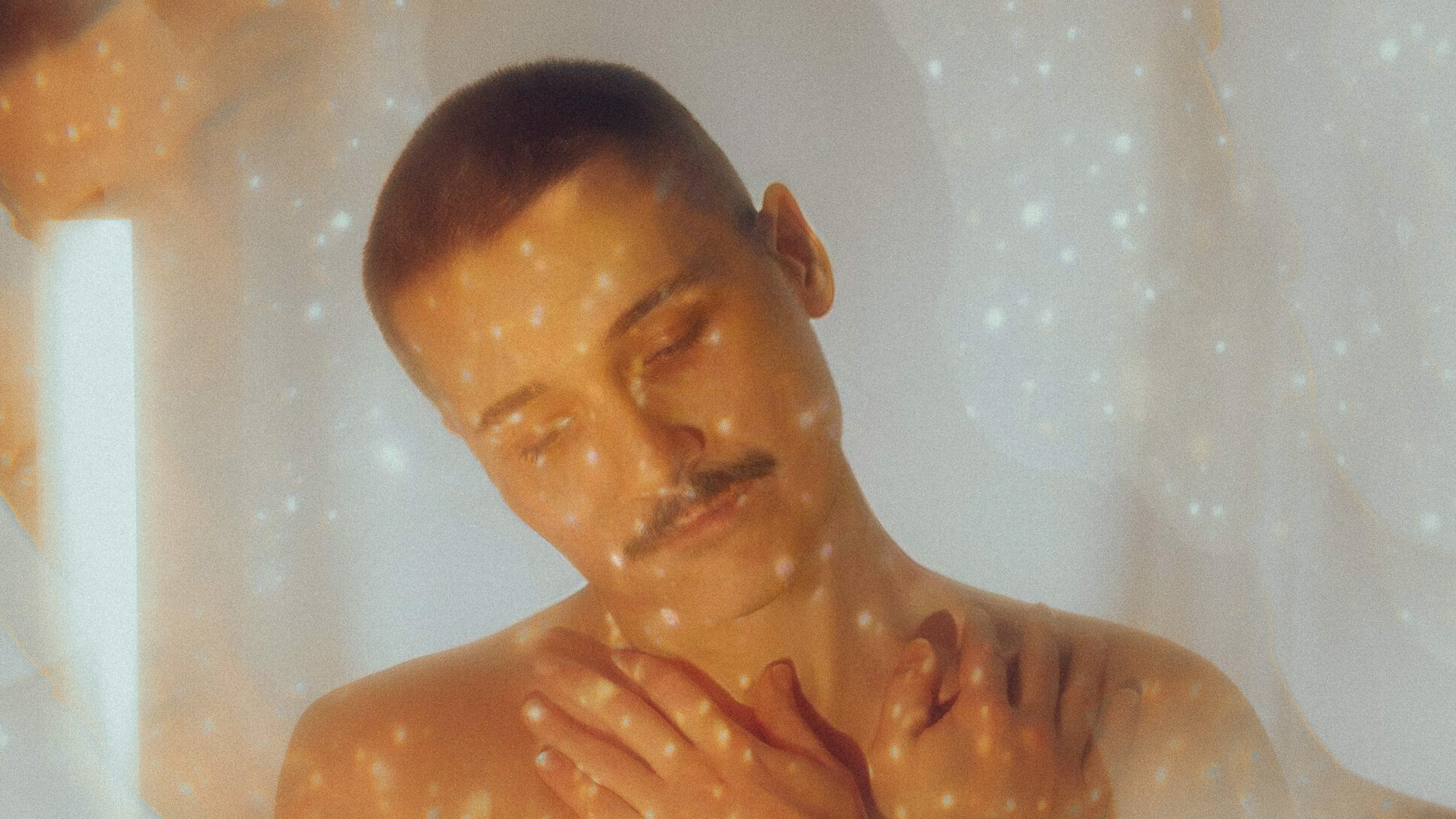 double exposure of a young man and shiny light dots.